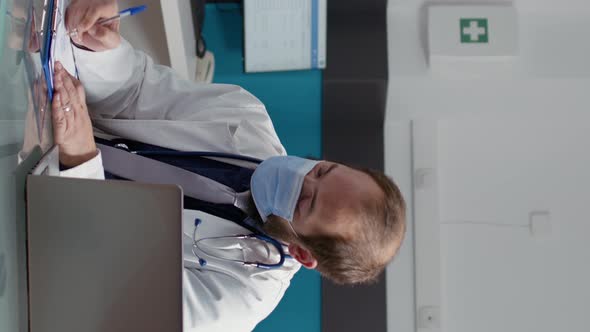 Vertical Video Health Specialist Giving Prescription Paper to Senior Patient alt