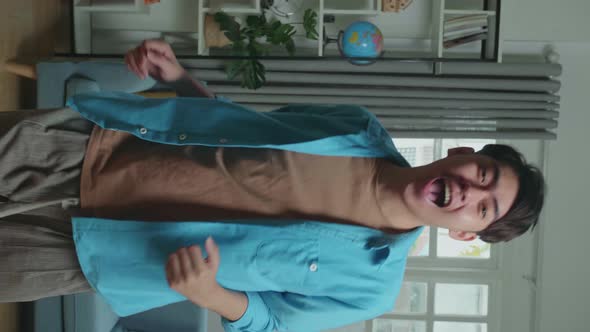 Asian Man Dancing While Shooting Video Content For Social Networks At Home alt