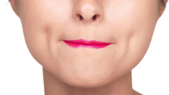 Cropped Footage of Joyful Woman with Perfect Skin Wearing Dazzling Pink Lipstick Smacking Her Lips alt
