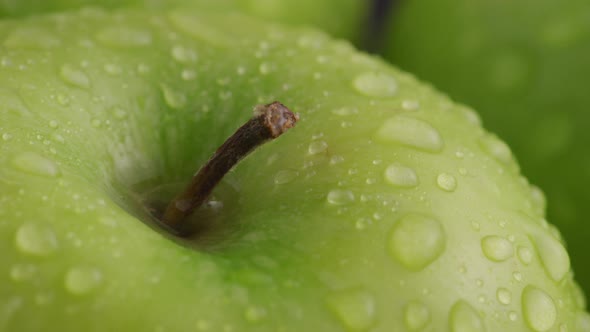Close-up of green apple with water droplets