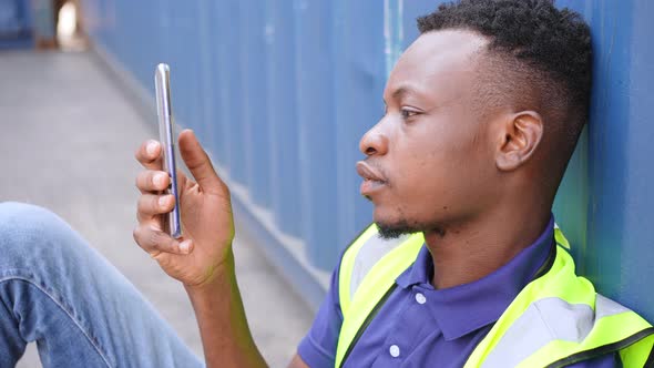 black men playing, online chatting or browsing on mobile phone