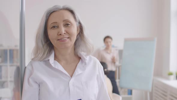 Portrait of Elderly Asian Businesswoman alt