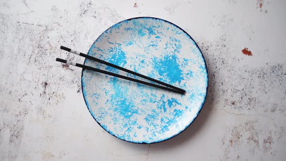 Blue Hand Painted Ceramic Serving Plate with Wooden Chopsticks on Side alt