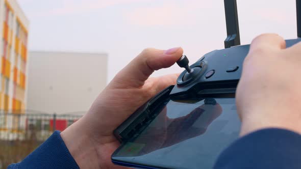 The Pilot Moves the Left Joystick on the Main Control Panel of the Drone alt