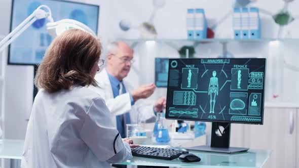 Female Researcher Types on Computer Keyboard alt