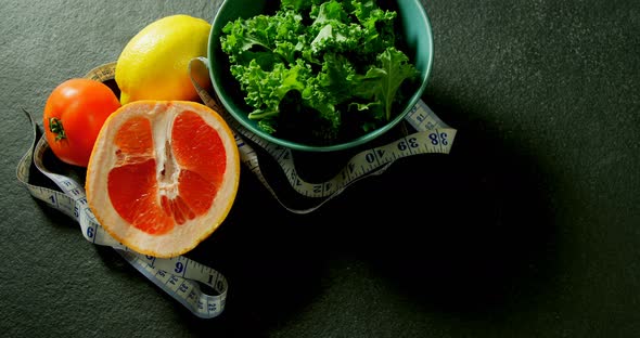 Leafy vegetable, sweet lime, lemon, tomato with measuring tape 4k alt