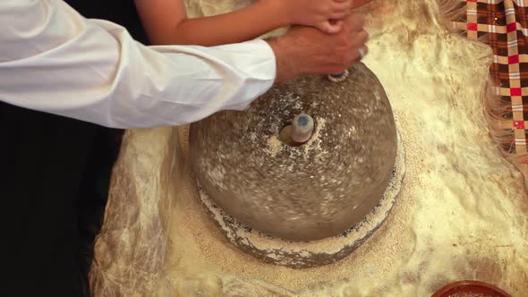 Crushing Wheat With Turning Stone To Make Flour 9 alt