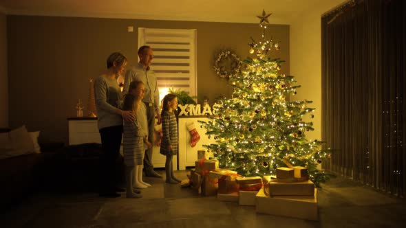 Family Singing in Front of Christmas Tree