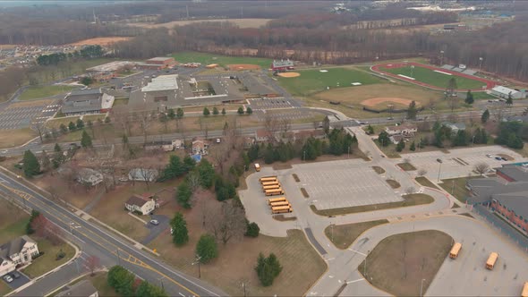 Middle of the Day on School Buses Parked Near the High School alt
