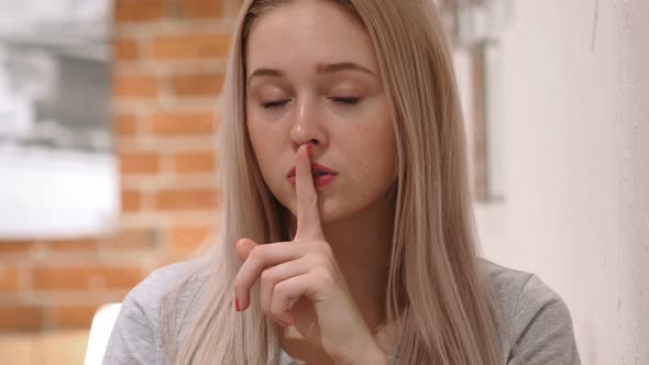Finger on Lips, Young Woman Asking for Silence alt