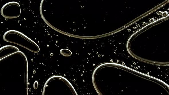 Transparent Cosmetic Gel Fluid with Molecule Bubbles Oil on Black Background alt