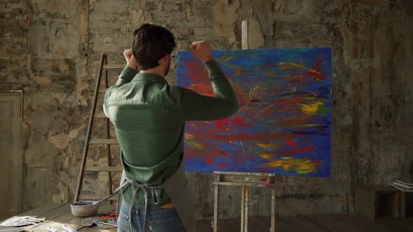 Male Artist Rejoices at the End of the Work Raising His Hands Up alt