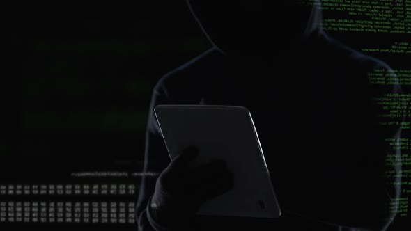 Dark Man Typing on Tablet Computer, Illegal Attack on Privacy, Cybercrime alt