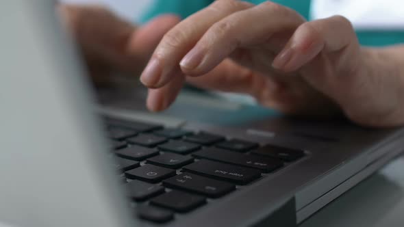 Elderly Person Typing on Laptop Keyboard, Modern Technologies for Retirees