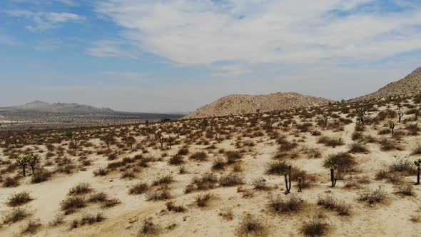 Drone video flying over an empty dry desert landscape in the middle of an uninhabited mountain range alt