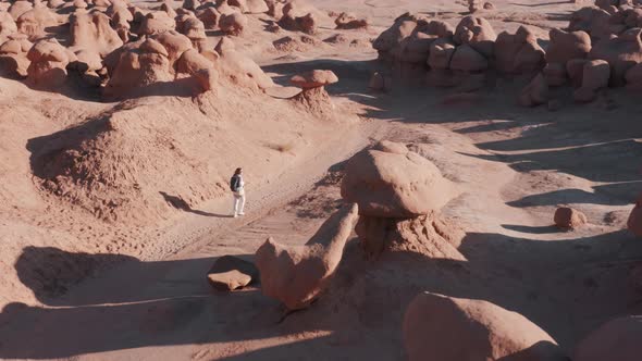 Tourist is Enjoying a Vacation in the Goblin Valley Utah Desert Footage alt