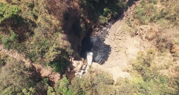 Drone footage birdseye point of view of big waterfall alt