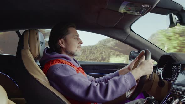 The driver driving the car listens to music and smiles.