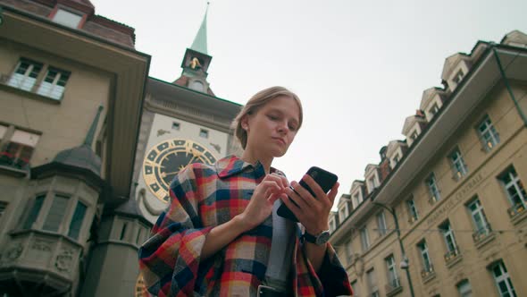 Person Uses Smartphone Mobile App Near Bern Landmark Clock Tower Switzerland