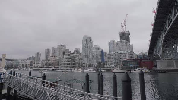 View of Yaletown apartments from Granville Island dock on cloudy day alt