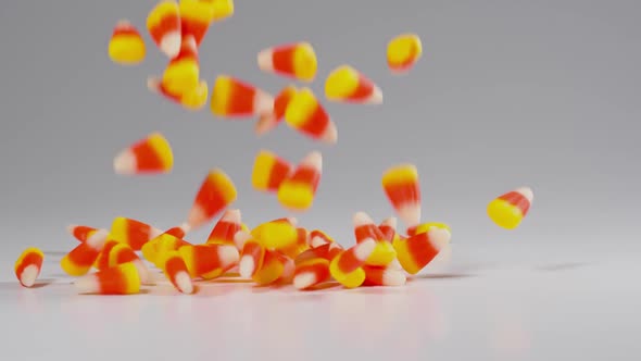 Time for Halloween. Delicious candy corn falls in slow motion. alt