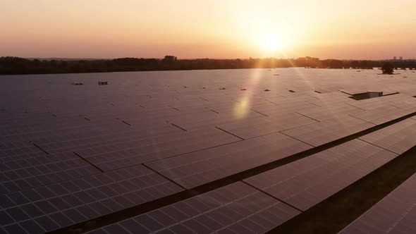 Aerial view over solar farm at sunrise