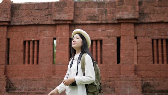 Woman visiting ancient temple alt