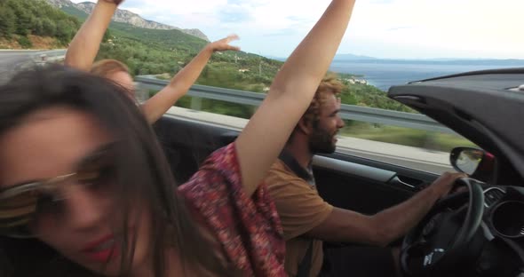 Three hipster friends having fun in convertible alt