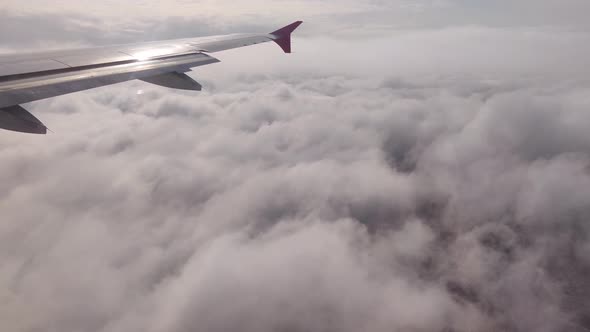 The Plane Is Flying Above The Clouds, View From The Porthole, Large Clouds, Travel