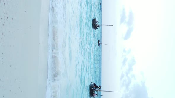 Vertical Video Boats in the Ocean Near the Coast of Zanzibar Tanzania Aerial View alt