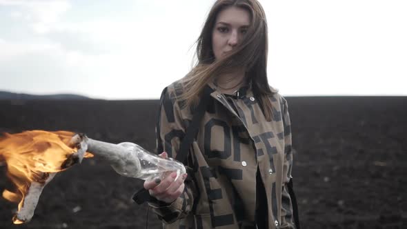 Girl in Coat Is Holding Molotov Cocktail
