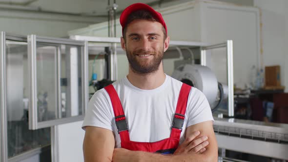 Portrait of a Young Caucasian Worker in a Warehouse or Factory