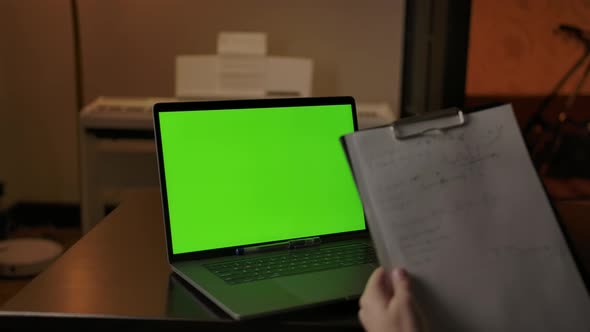 Writing Scientific Notes Behind Green Screen Laptop at Home alt