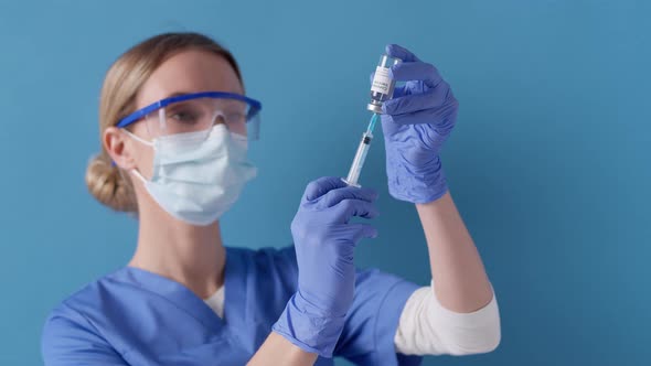 Medical nurse filling syringe with medicine. Vaccinations