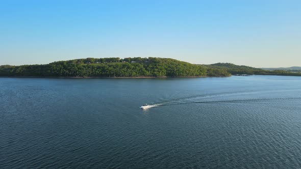 Aerial Birds Following View of a Hige River Bay and the Green Rainforest Under the Setting Sun