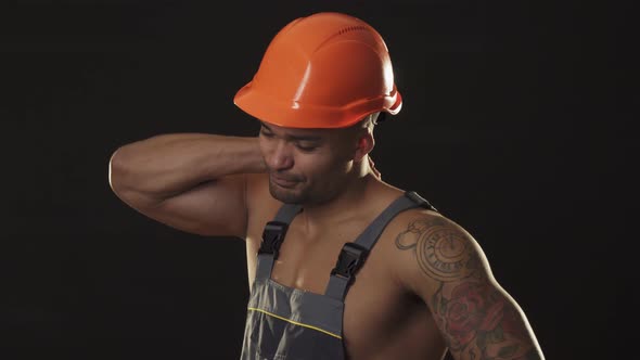 Handsome Muscular Constructionist Rubbing His Neck Looking Disappointed alt