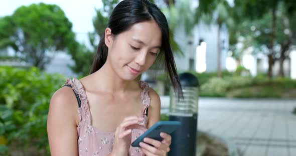 Woman use of mobile phone in city alt