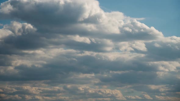 Timelapse White Fluffy Clouds Float Across the Blue Sky alt