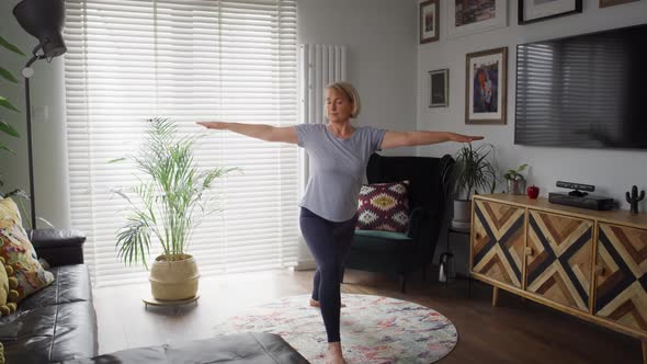 Video of active senior woman exercising at home. Shot with RED helium camera in 8K. alt