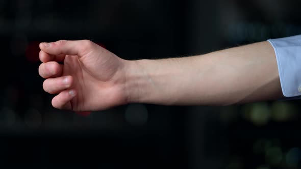 Macro of Man Hand Rolling Sleeve on Black Background, Stock Footage