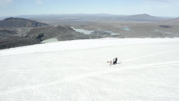 Aerial view of a snowmobile on one ski, top of the Langjokull glacier, in sunny Iceland alt