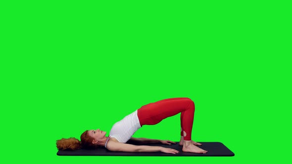 Slim Sporty Woman Doing Glut Bridge While Practicing Yoga On Green Screen