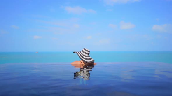 Young asian woman enjoy around outdoor swimming pool for leisure alt