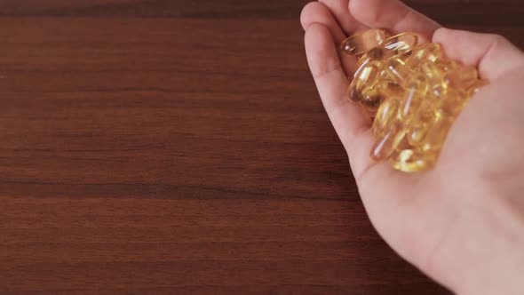 Man Hands Holding Omega 3 Capsules