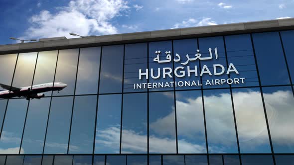 Airplane landing at Hurghada Egypt airport mirrored in terminal alt