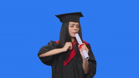 Portrait of Female Student in Graduation Costume Holding Diploma Dancing and Singing Merrily alt