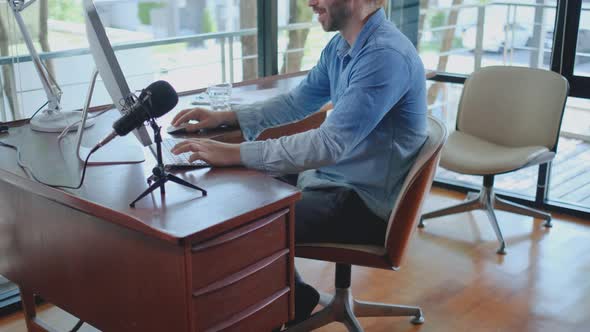 Side view handsome man work at home. He action of typing, looking to computer alt