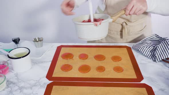Step by step. Pouring caramelized sugar on a silicone baking mat to make homemade lollipops. alt