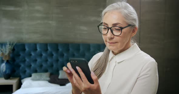 Elderly Woman Texting on Smartphone