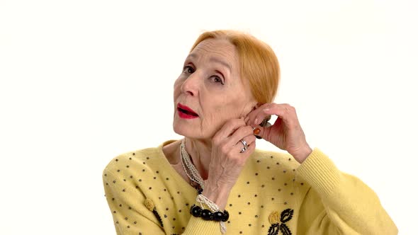 Woman Fixing Earrings alt